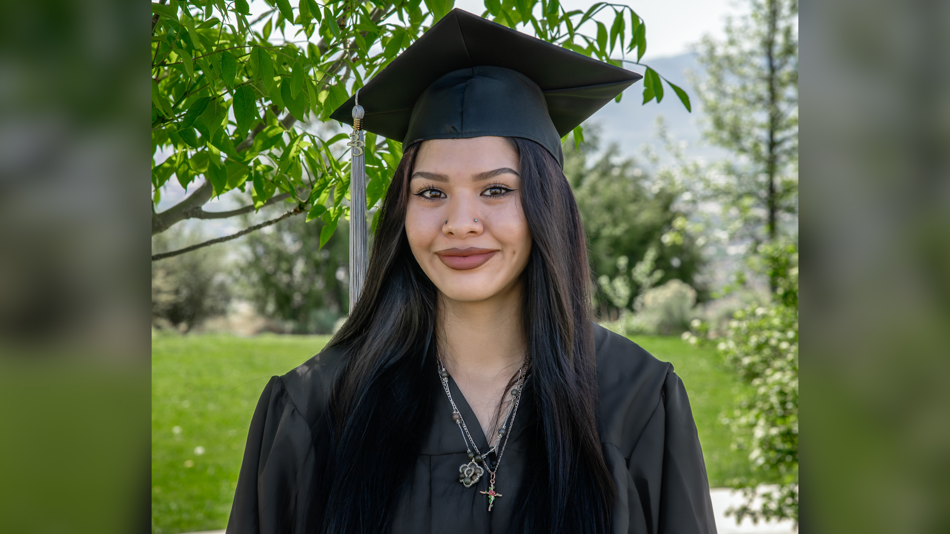  young woman wearing graduation cap and gown